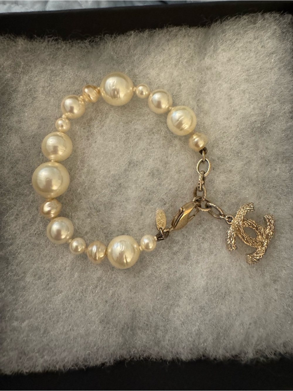 Authentic CHANEL Gold and Ivory Pearl Bracelet with Textured CC Charm